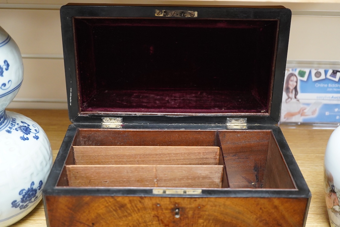 A George III and later flame mahogany veneered writing box raised on ball feet, 30cm wide